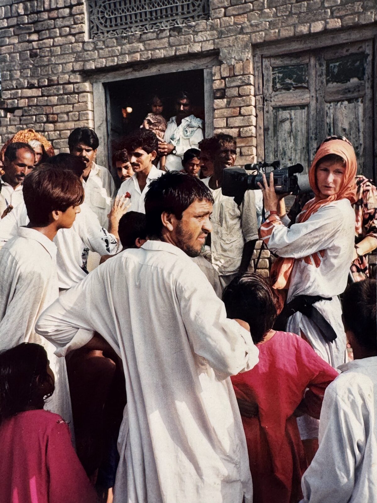 Filming amid a village crowd