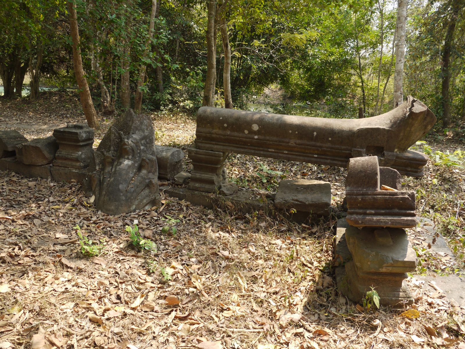 Carved stone fragments scattered in the forest